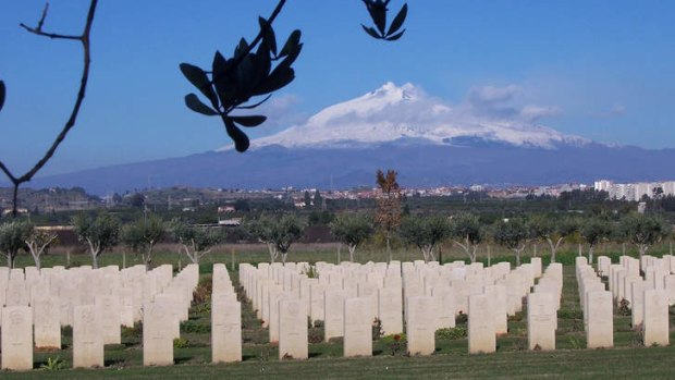 Catania Commonwealth War Cemetery with Mount Etna in background in Sicily, Italy.