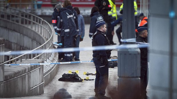 Police survey the scene after an attack in a crowded square in the Belgian city of Liege.