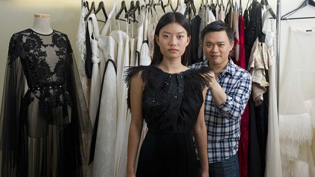 Brisbane designer George Wu fits Asia Pacific Screen Awards hostess Rachel Choi with a gown at his Mt Gravatt studio.
