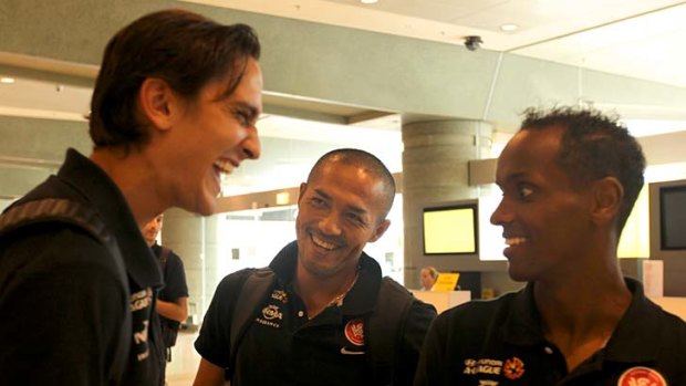 Good times ahead ... three of Western Sydney's imports - Jerome Polenz, Shinji Ono and Youssouf Hersi - laugh at Sydney Airport on Monday after the Wanderers' win over Brisbane Roar.