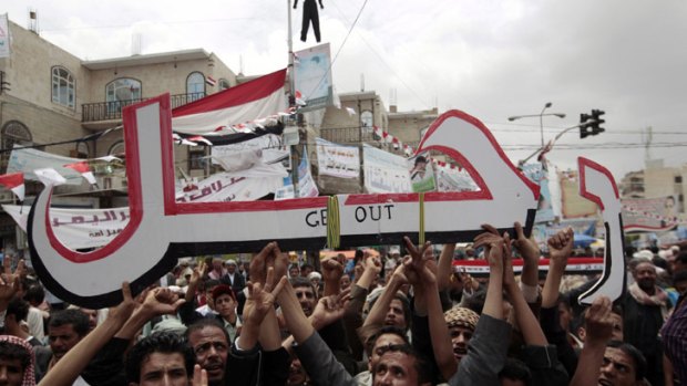 Anti-government protesters hold a sign that reads 'leave' during a rally to demand the ouster of Yemen's President Ali Abdullah Saleh.