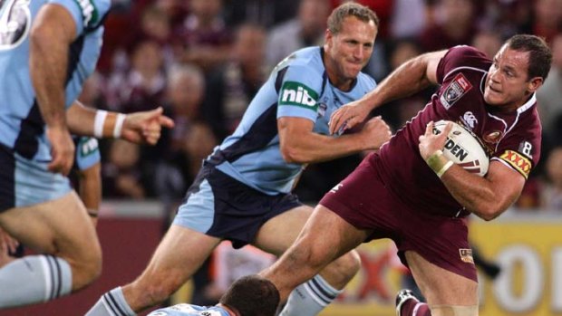 Stepping up ... Matt Scott challenges the NSW line during his stand-out performance for the Maroons on Wednesday night.