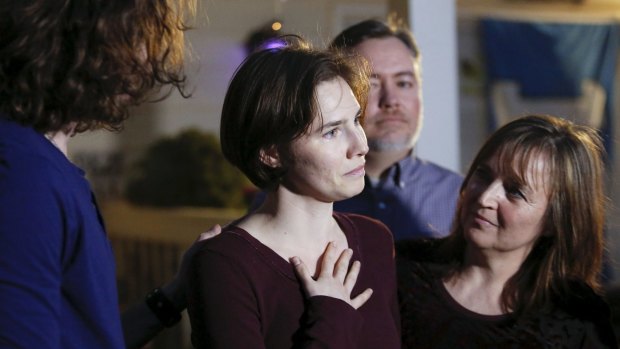 Amanda Knox talks to the press surrounded by family outside her mother's home in Seattle on Friday. 