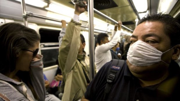 Health nightmare...passengers on the Mexico City metro wear masks in an attempt to protect themselves after dozens of people died of swine flu.