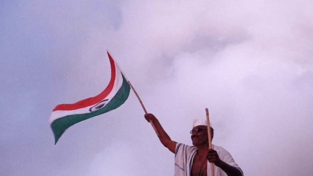 A supporter of Anna Hazare waves an Indian national flag at the Bandra Kurla Ground complex, where a public fasting is being held.