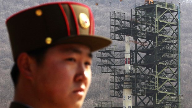 A North Korean soldier stands guard at the rocket site before the launch.