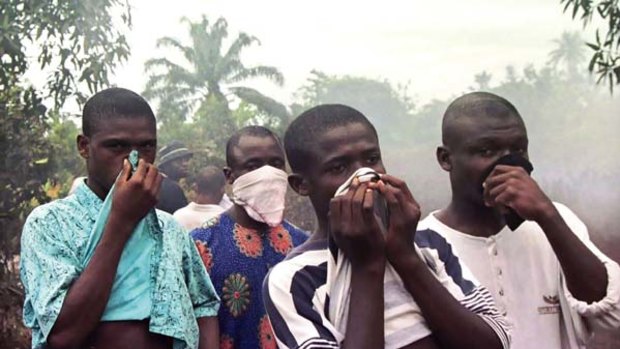 On the nose ... Ogoni villagers react to the stench from a Shell oil spill that was turning their drinking water black.