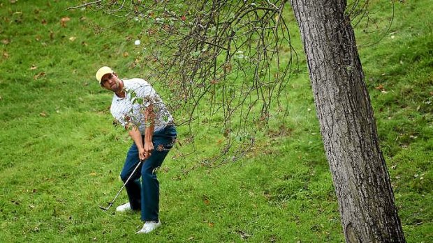 Cross-country golf: Adam Scott plays a shot from the rough on the 11th hole.