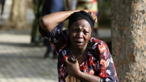 A bystander reacts as victims of a bomb blast arrive at the Asokoro General Hospital in Abuja on Monday.