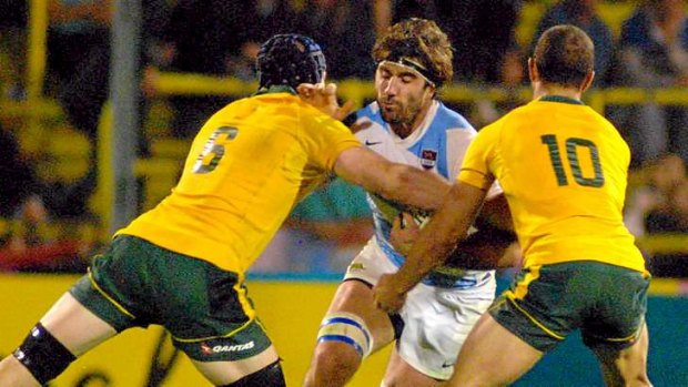 Wall of Wallabies: Scott Fardy (left) tackles Argentina's Juan Martin Fernandez Lobbe in the 54-17 romp over the Pumas.