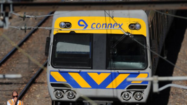 Workers hose down tracks at Jolimont after the rail lines buckled in extreme heat.