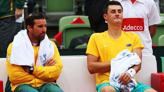 In better days: Bernard Tomic (right) and Pat Rafter chat during the Davis Cup World Group playoff match between Germany and Australia on September 14 last year.