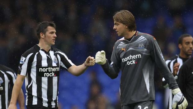 Out of action . . . Joey Barton, left, gently taps Newcastle goalkeeper Tim Krul but it's his fists that have landed him on hot water again.