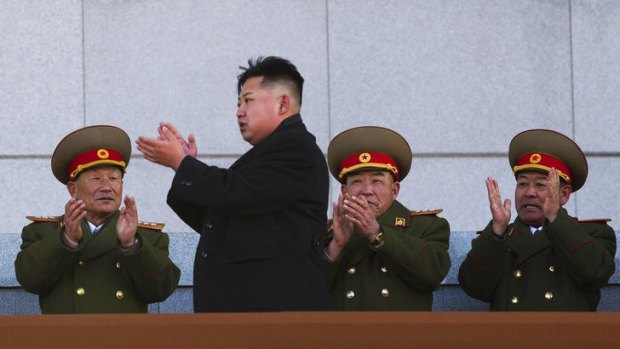 Kim Jong-un, second from left, applauds as he leaves the stands at Kumsusan Memorial Palace in Pyongyang after reviewing a parade of thousands of soldiers and commemorating the 70th birthday of the late Kim Jong Il.