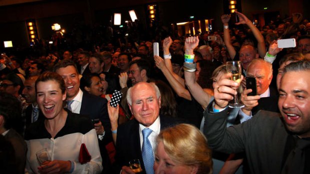 Former Australian PM John Howard celebrates as Australian Prime Minister-elect, Tony Abbott, claims victory in the 2013 Australian Election on September 7, 2013.