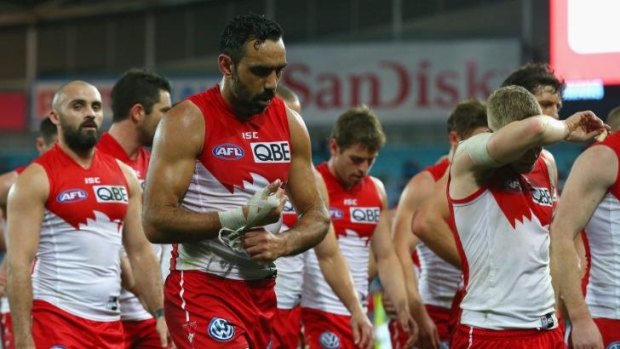 Adam Goodes and the Swans team are a picture of dejection after losing to the Tigers.
