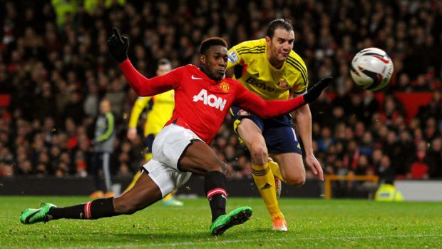 Desperate scramble: Danny Welbeck of Manchester United gets off a shot on goal under pressure from John O'Shea of Sunderland.