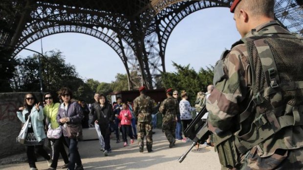 Heightened security: Soldiers patrol near the Eiffel Tower in Paris, France.