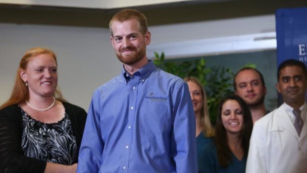 Dr Kent Brantly (right), stands with his wife, Amber Brantly, during a press conference announcing his release from Emory Hospital.