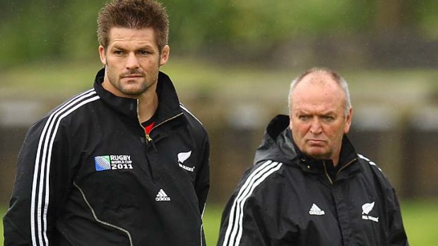 On the sidelines ... Richie McCaw and New Zealand coach Graham Henry watch on at training in Auckland today.