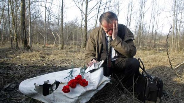 Polish Ian Grushinski grieves at the site of the plane crash that killed Polish President Lech Kaczynski.