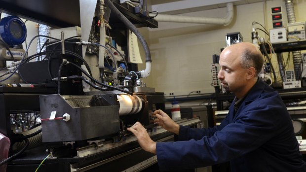 Kodak print head engineer Todd Griffin makes a demo print with a high speed drum at Kodak research labs.