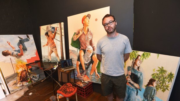 Artist Fintan Magee with some of his work from his Water World exhibition which is inspired by the Brisbane floods. 