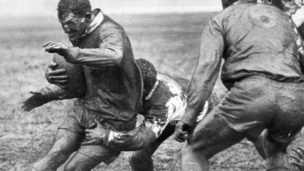 Mudbath &#8230; Magpies five-eighth Arthur Summons is tackled by St George in the 1963 grand final.