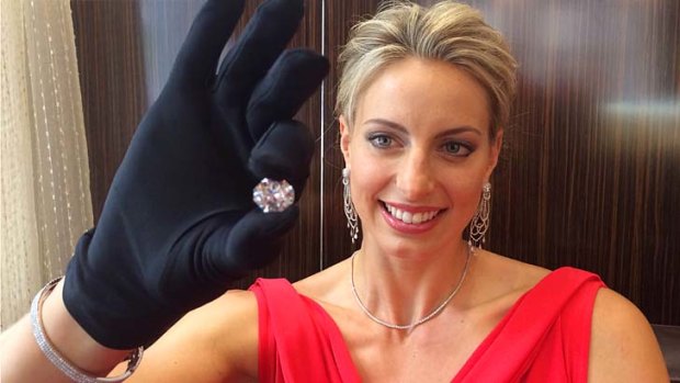 Queensland netball star Laura Geitz carefully holds the rare 12.66 carat diamond.