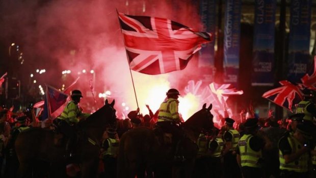 Police stand guard while Union loyalists clash with independence campaigners in Glasgow's George Square.