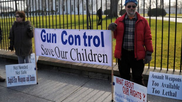 New laws ... Demonstrators seek tighter gun controls during their protest outside the White House in Washington.