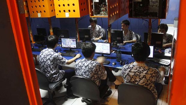Indonesian students browse at an internet cafe in Jakarta.