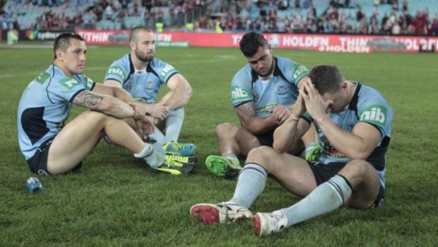 Despair: Mitchell Pearce, Aaron Woods, Andrew Fifita and Robbie Farah come to terms with defeat in 2013.