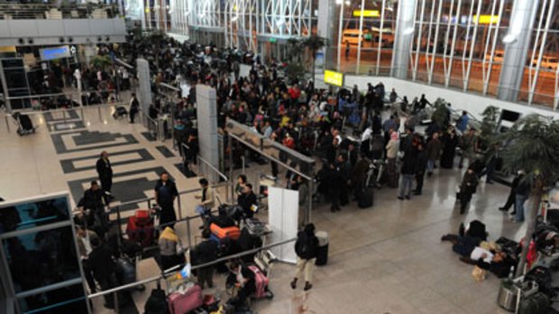 People gather in Cairo's international airport as they wait to check-in for flights.