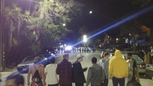 A crowd confronting police at a disturbance during a weekend college party in Southern California that devolved into a street brawl.