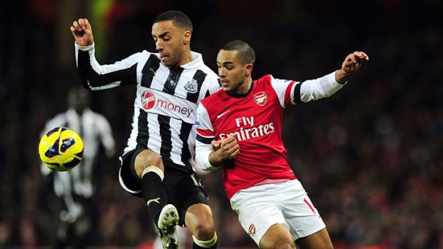 Newcastle United defender James Perch (left) tries to get the better of Arsenal striker Theo Walcott.