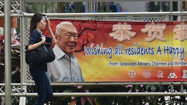 A pedestrian this week walks past a banner displaying an image of Singapore's founding father, Lee Kuan Yew.
