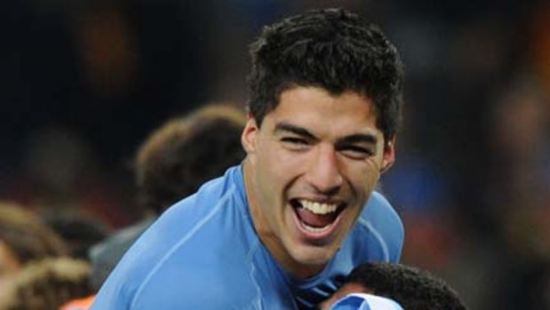 Happy ... Luis Suarez, top, celebrates after the match.