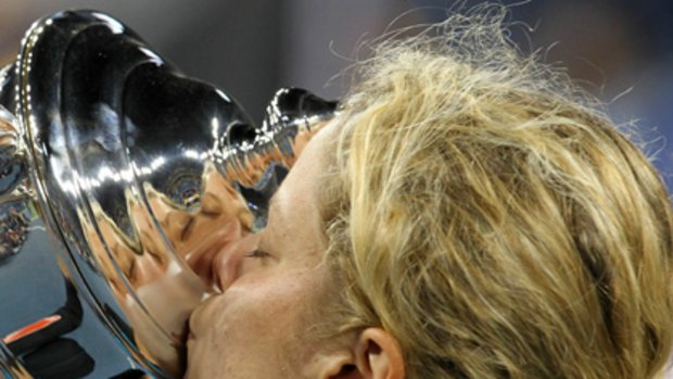 Belgium's Kim Clijsters kisses the trophy in celebration.