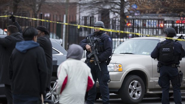 A police officer keeps guard after the shooting.