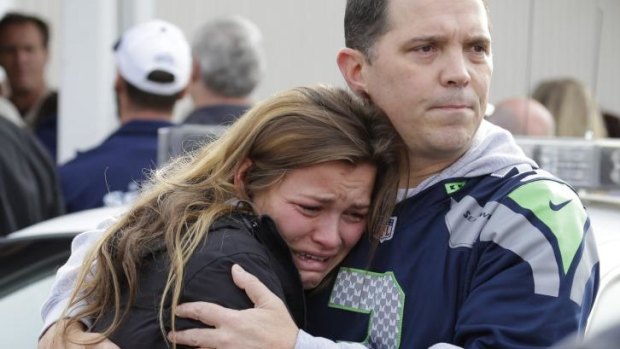 People react as they wait at a church, where students were taken to be reunited with parents following a shooting at Marysville Pilchuck High School in Marysville.