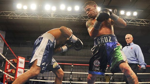 Boxer Orlando Cruz, right, battles Alejandro Delgado during a fight at the Palm Bay Community Center in Florida in February.