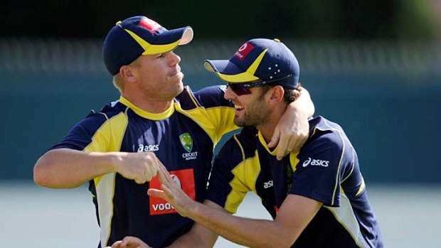 In a spin: David Warner (left) gets up close and personal with Nathan Lyon.