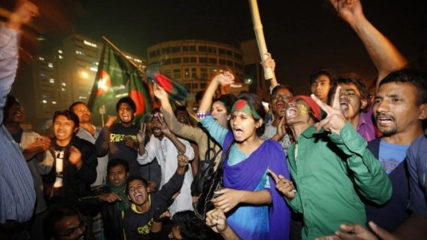 People celebrate after hearing the news of  Bangladesh Jamaat-e-Islami leader Abdul Quader Mollah's execution.