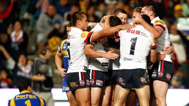 Roosters players celebrate after scoring against the Eels at the weekend.
