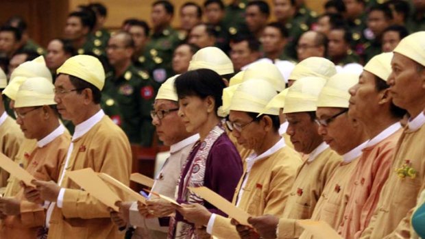 More than words ... Burma's Opposition leader and pro-democracy advocate Aung San Suu Kyi reads an oath with other elected members in Naypyidaw.