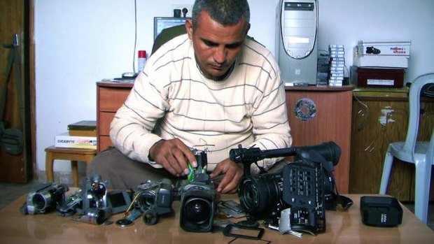Emad Burnat with his five broken cameras. Burnat and Guy Davidi co-directed the Oscar-nominated documentary 5 Broken Cameras.