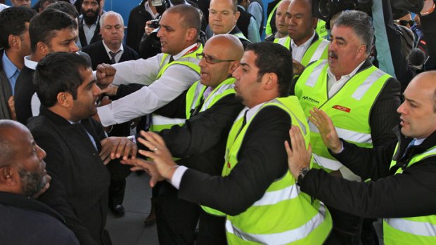 Angry taxi drivers clash with airport security staff on Friday.