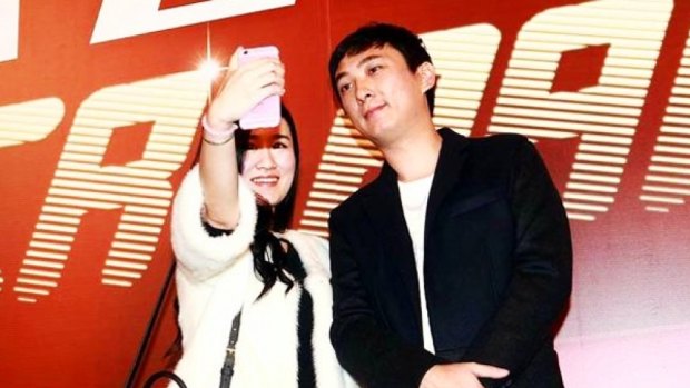 An unidentified woman takes a selfie with Wang Sicong, the son of China's wealthiest man, Wang Jianlin.