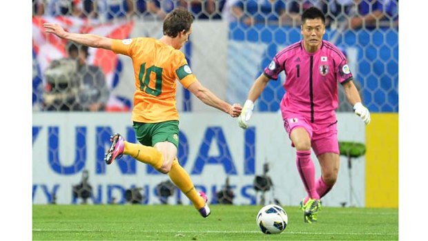 Australia's Robbie Kruse gets set for a shot at goal as Japan's goalkeeper Eiji Kawashima advances.